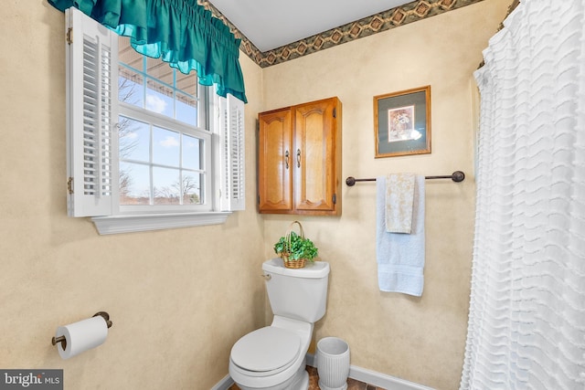 bathroom with toilet and walk in shower