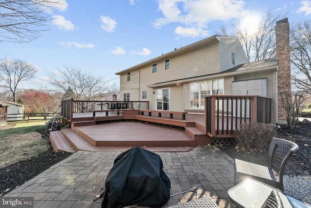 back of property with a patio and a wooden deck