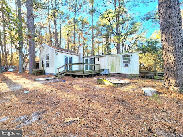 rear view of property with a wooden deck