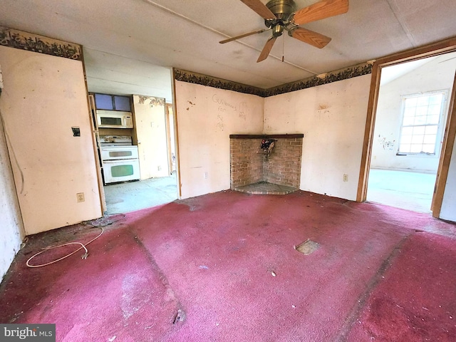 unfurnished living room with ceiling fan