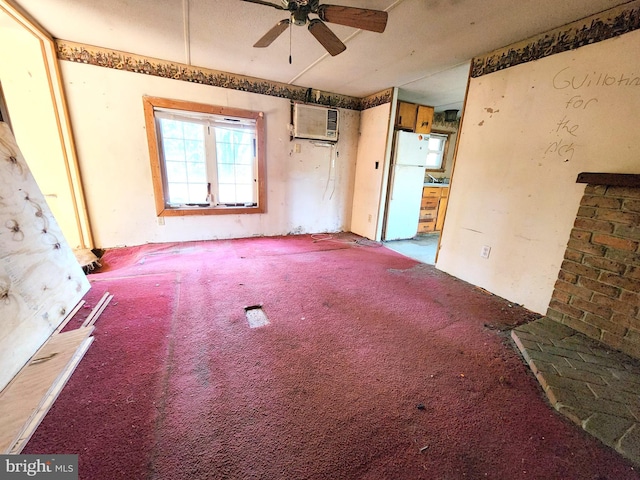 carpeted empty room featuring a wall unit AC and ceiling fan