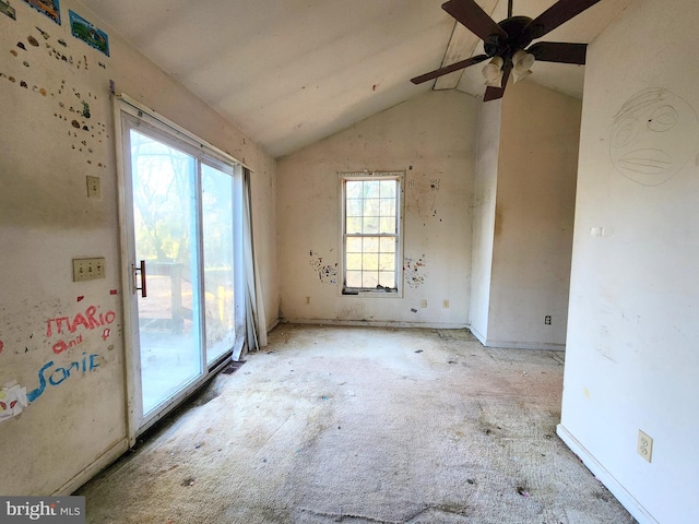 empty room featuring ceiling fan and lofted ceiling