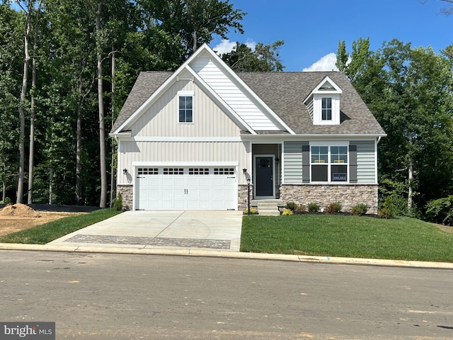 view of front of home with a front lawn and a garage