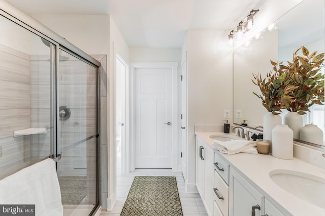 bathroom featuring vanity and a shower with door