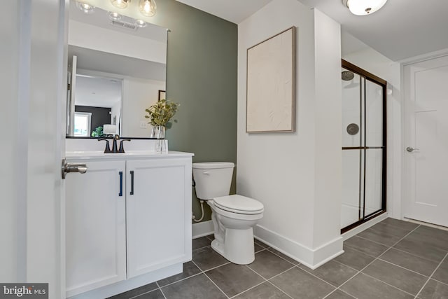 bathroom with tile patterned flooring, vanity, toilet, and an enclosed shower