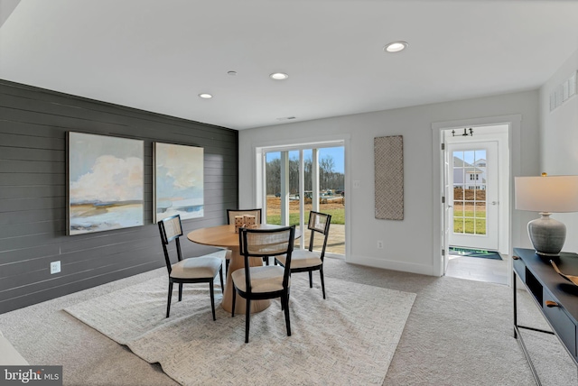 dining space with light colored carpet