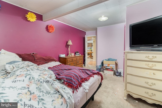 carpeted bedroom featuring beamed ceiling