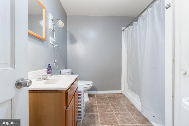 bathroom with tile patterned floors, vanity, curtained shower, and toilet