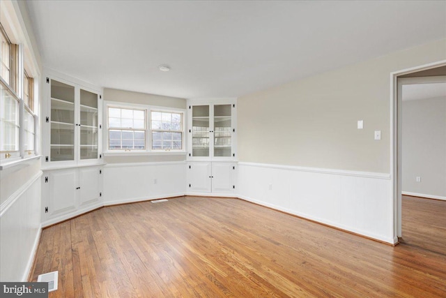 unfurnished room with light hardwood / wood-style floors