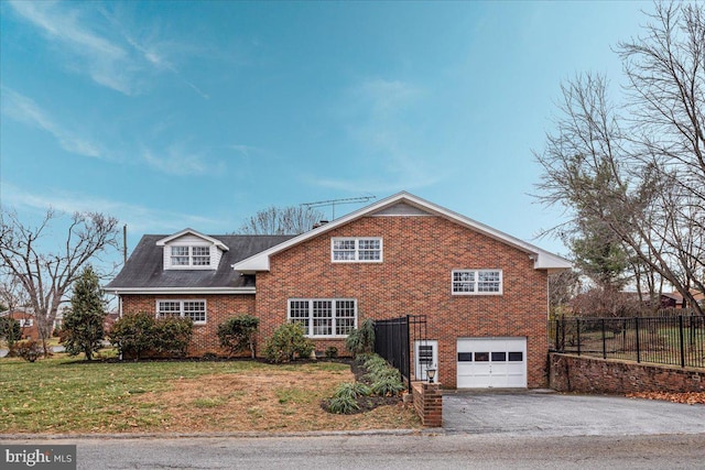 view of property featuring a front yard and a garage