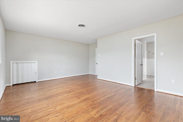 empty room with light hardwood / wood-style flooring