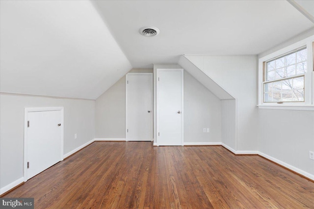 bonus room featuring dark hardwood / wood-style flooring and vaulted ceiling