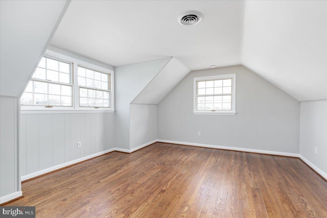 bonus room featuring lofted ceiling and dark wood-type flooring