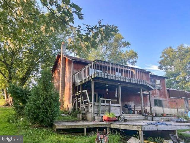 back of property with a wooden deck