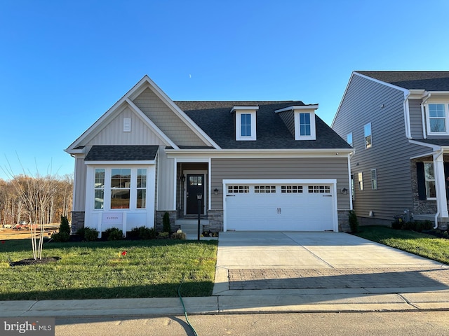 view of front of home featuring a garage and a front lawn