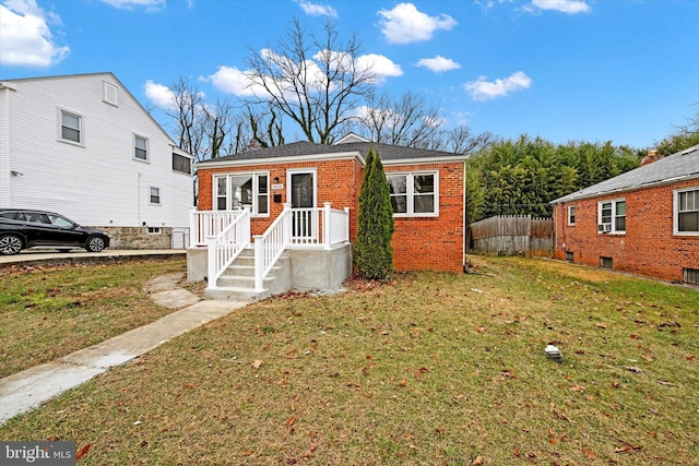 bungalow-style home featuring a front lawn