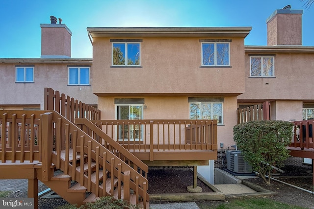 rear view of property with cooling unit