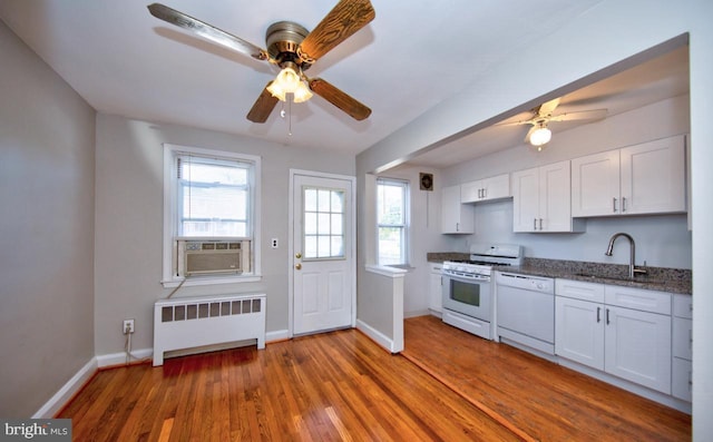 kitchen featuring white cabinets, dark hardwood / wood-style flooring, white appliances, and radiator