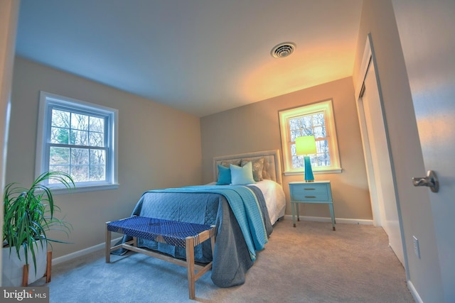 bedroom featuring light colored carpet