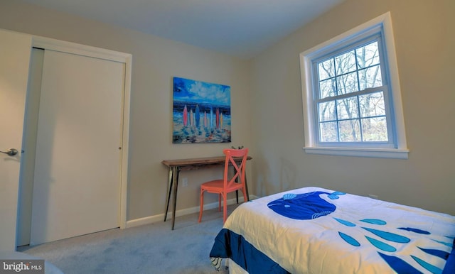 bedroom featuring light carpet and a closet