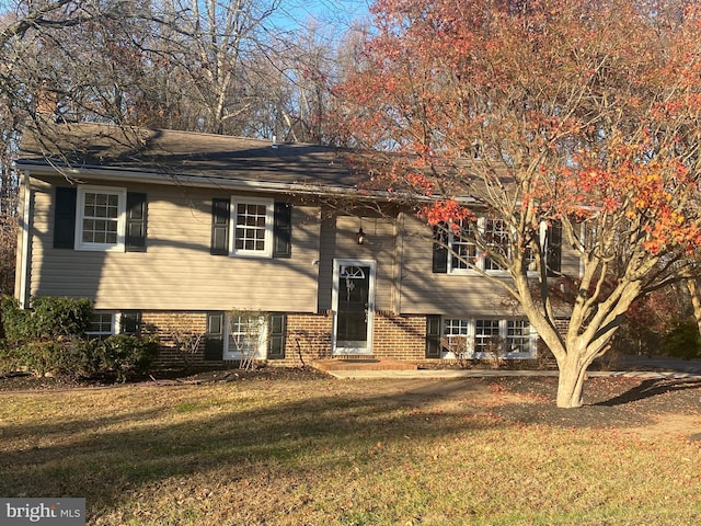 raised ranch with a front lawn