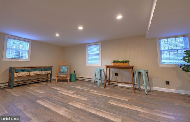 living area with hardwood / wood-style flooring and a baseboard radiator