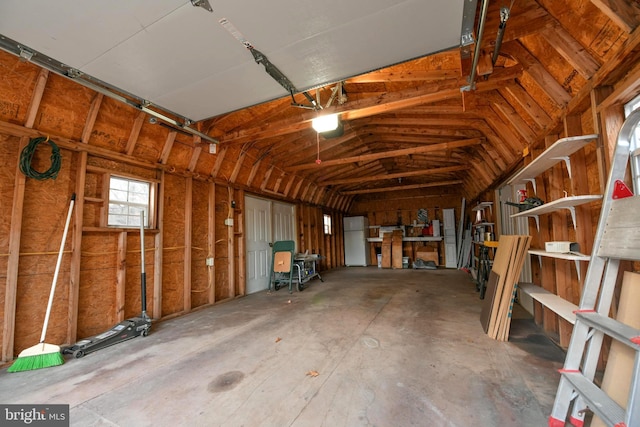 garage with white refrigerator and a garage door opener