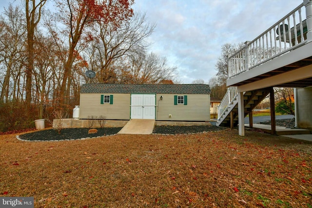 exterior space with a wooden deck and an outbuilding