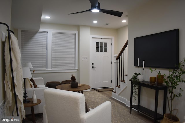 living room with hardwood / wood-style flooring and ceiling fan