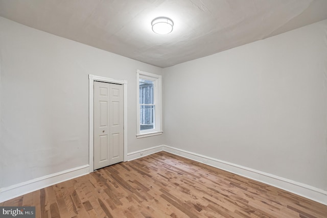 unfurnished room with hardwood / wood-style flooring