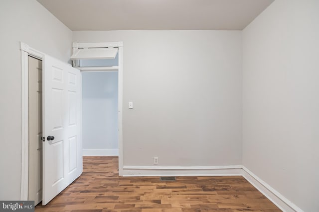 unfurnished room featuring hardwood / wood-style floors