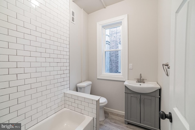 full bathroom featuring vanity, wood-type flooring, shower with separate bathtub, and toilet