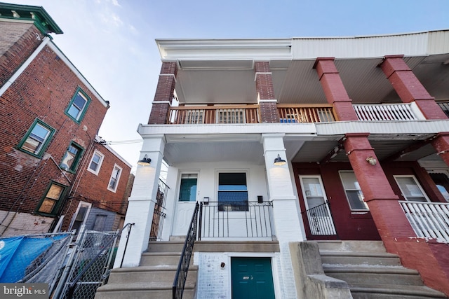 view of front of home with covered porch and a balcony