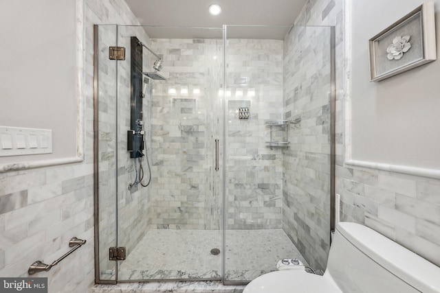 bathroom with toilet, tile walls, and walk in shower