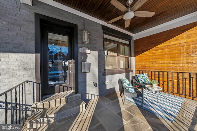 entrance to property featuring ceiling fan and a porch