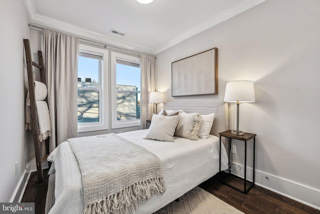 bedroom with crown molding and dark wood-type flooring