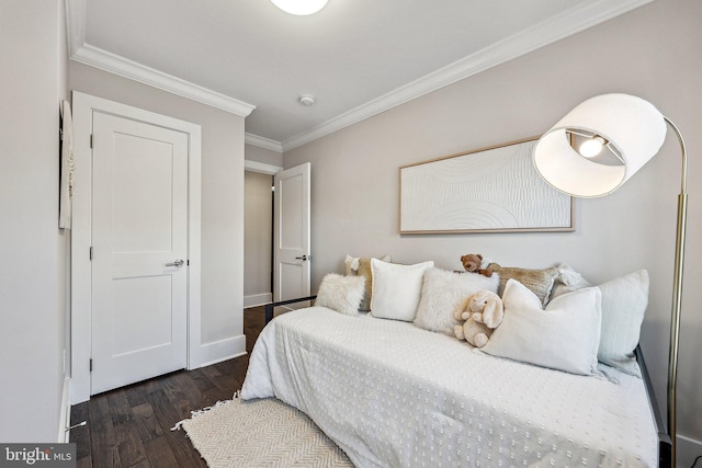 bedroom with crown molding and dark hardwood / wood-style floors