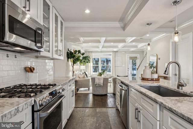 kitchen featuring white cabinetry, sink, coffered ceiling, beamed ceiling, and appliances with stainless steel finishes