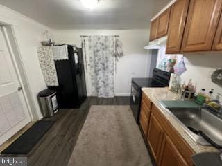 kitchen with dark hardwood / wood-style flooring, electric range, and sink