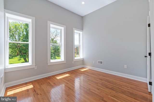 unfurnished room with hardwood / wood-style floors