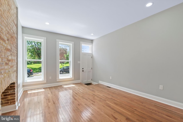 interior space featuring a large fireplace and light wood-type flooring