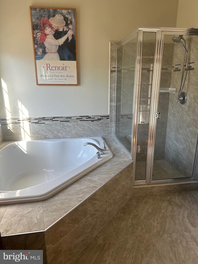 bathroom featuring shower with separate bathtub