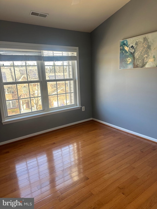 spare room with hardwood / wood-style flooring