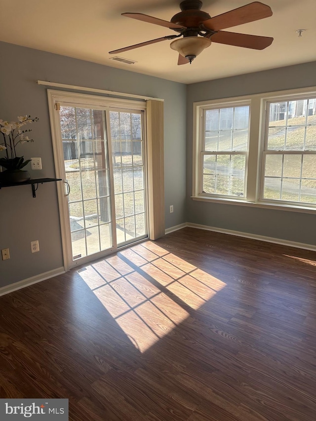 unfurnished room featuring ceiling fan and dark hardwood / wood-style flooring