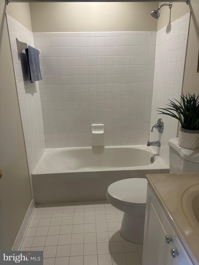 full bathroom featuring tile patterned floors, toilet, tiled shower / bath combo, and vanity