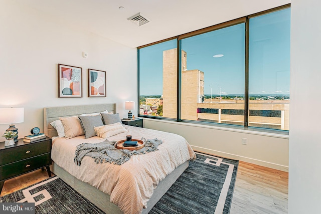 bedroom with hardwood / wood-style floors