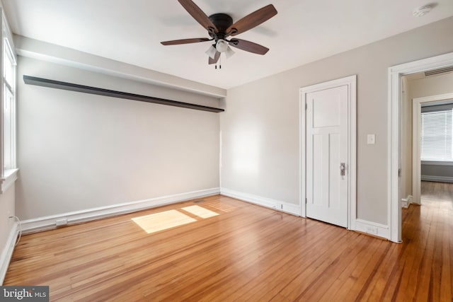 empty room with light hardwood / wood-style flooring and ceiling fan