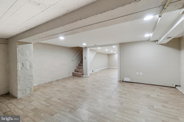 basement with light hardwood / wood-style floors