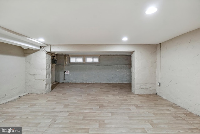 basement with light hardwood / wood-style floors