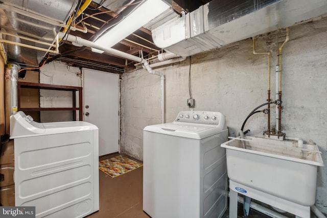 washroom with independent washer and dryer and sink